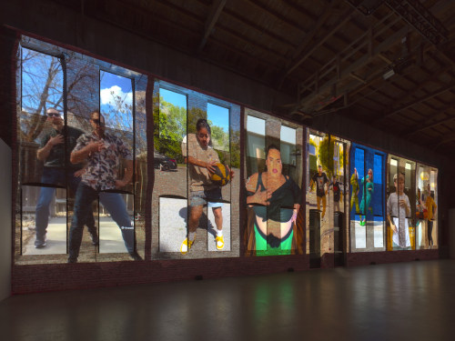 Brick wall with projection of dance videos