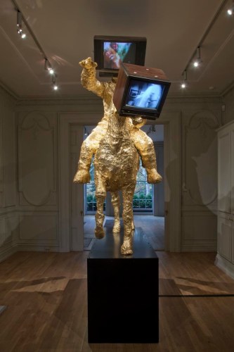 Gold leaf sculpture of a man on a horse with both heads replaced with televisions by The Bruce High Quality Foundation