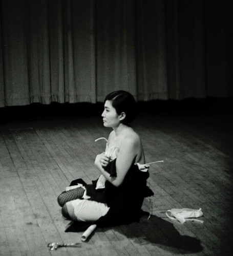 Yoko Ono performing Cut Piece (1964) at Carnegie Recital Hall, NYC. March 25, 1965. Photo by Minoru Niizuma ©Yoko Ono⁠