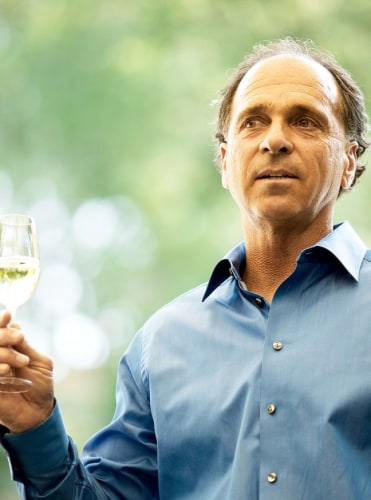 David Abreu, Kenzo Estate viticulturist, holds a glass of wine