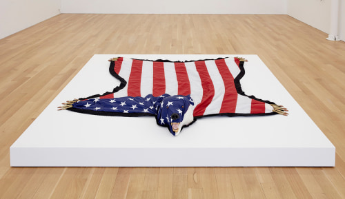 Installation view of The American Dream is Alie and Well, 2012, US flag, felt, .50 cal ammunition, foam, gold leaf and plastic, 84 x 84 x 9 inches (213.4 x 213.4 x 22.9 cm)