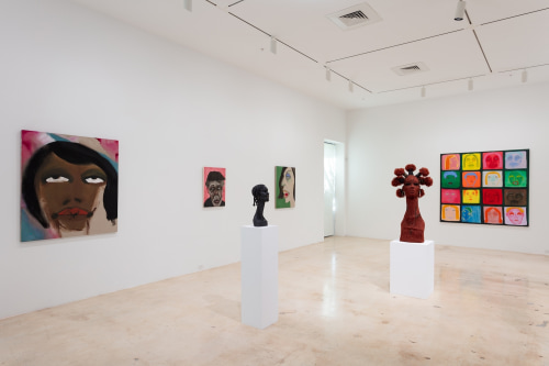 This is an image of an installation of paintings by February James and sculptures by Murjoni Merriweather