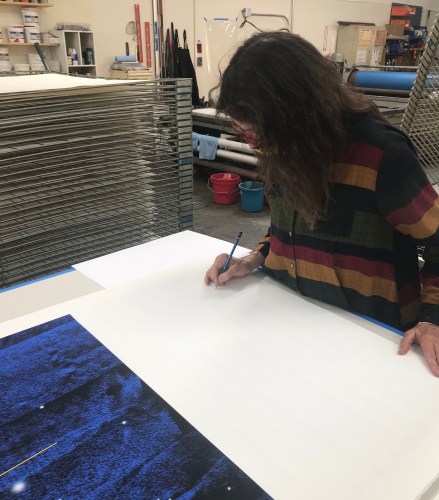 Lita Albuquerque signing her prints at the Cirrus workshop, March 2021