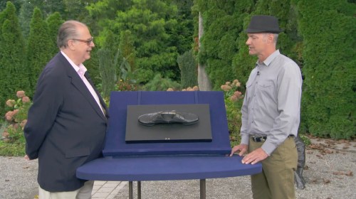 eric silver with an antiques roadshow guest and an early sculpture by ai wei wei of two leather shoes affixed to a board