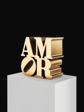 Bronze AMOR sculpture, with the letters A and M on top of a tilted letter O and the letter R