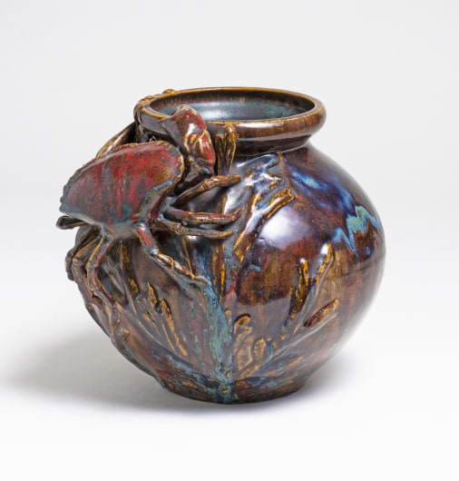 a sang de boeuf glazed vase by pierre adrien dalpayrat, the dripping glaze in oxblood red with touches of blue and purple, the round body of the vase with applied seaweed fronds with a sculptural three dimensional crab placed near the rim