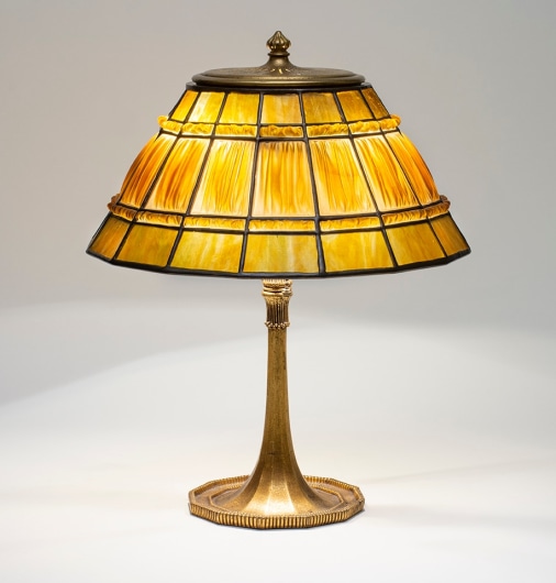 a tiffany lamp with linenfold or favrilefabrique shade, the paneled shade formed by flattened pressed tiffany glass panels with a trompe l'oeil effect mimicking pleated silk shades
