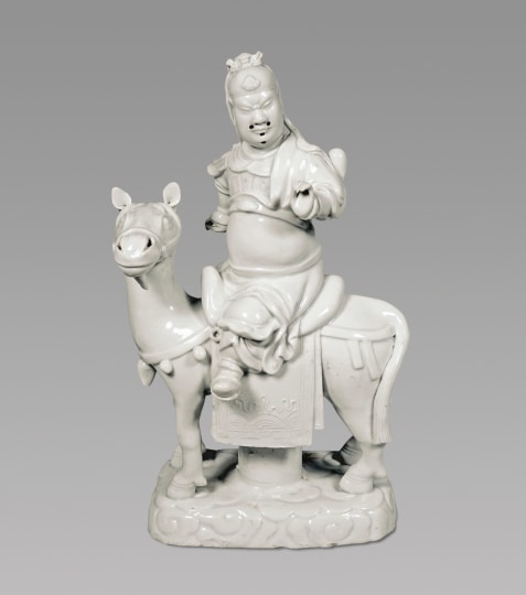 . Blanc de Chine Porcelain Group of Guandi Riding upon his Horse