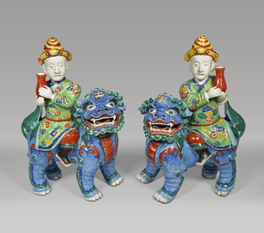 Pair of Chinese Porcelain Figures of Foreigners Riding upon Fu Lions