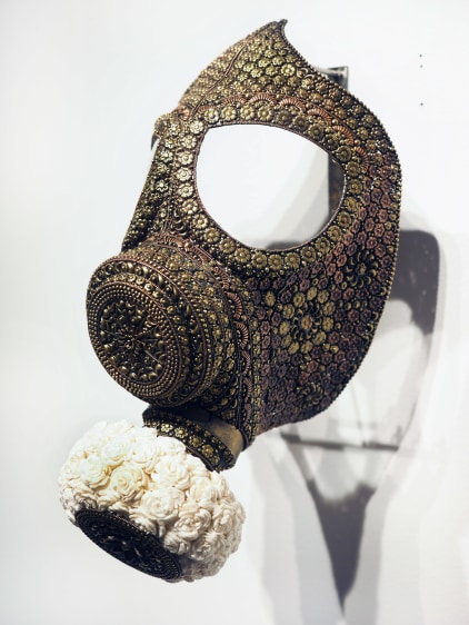P.D. Pulak Untitled (Gas Mask for the Rich &amp; Famous) Shola flowers, brass  Dimensions variable