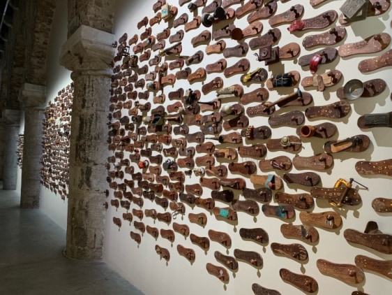 G. R. Iranna  Naavu (We Together)  2012  Wood and mixed media  Dimensions variable, site specific  500-650 padukas