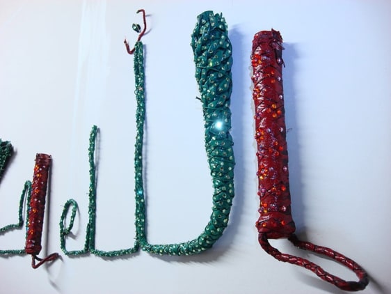 Jaishri Abichandani  Allah Hu Akbar  2008  Leather whips, wire, paint, and swarovski crystals  16 x 54.5 in.