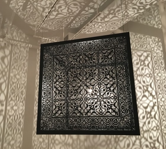 Anila Quayyum Agha Shimmering Mirage 2016 Laser-cut black steel and bulb 36 x 36 x 36 in.
