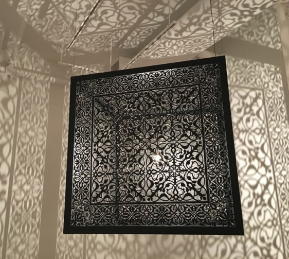 Anila Quayyum Agha Shimmering Mirage 2016 Laser-cut black steel and bulb 36 x 36 x 36 in.