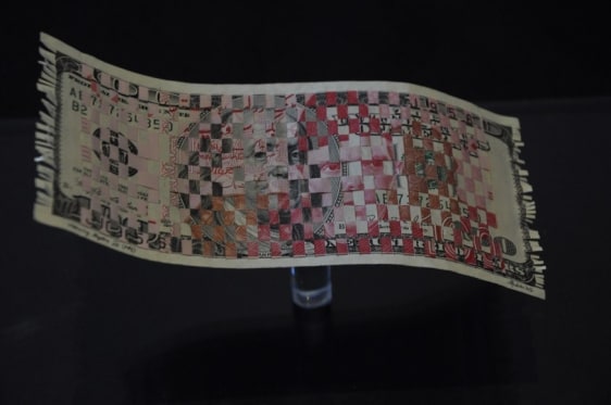 Abdullah M. I. Syed Weaving Myth VII 2014 Hand cut and woven U.S. $100 banknote and Pakistani 100 Rupee banknote in custom-made Perspex vitrine 10 x 6 x 5.5 in.