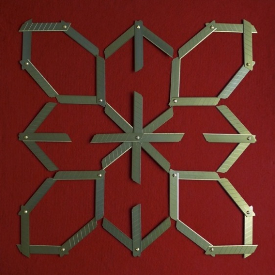 Abdullah M. I. Syed Margin of Error - Rosette on Red (Ed. of 5) 2017 Titanium utility knife blades, brass, stainless steel, felt and tempered hardwood 23 x 23 in.