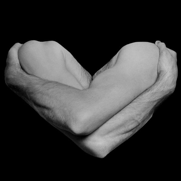 Two arms crossed forming the shape of a heart.