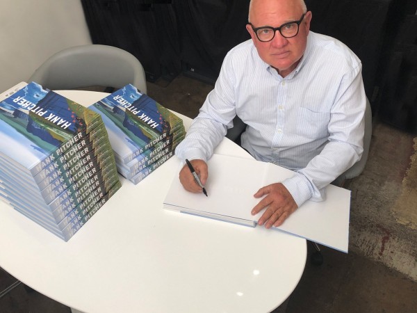Photograph of HANK PITCHER signing his new monograph for a Noozhawk article