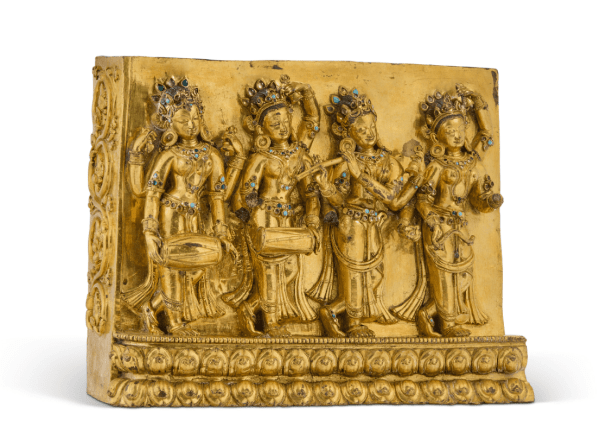 A RARE GILT-COPPER ALLOY PLAQUE DEPICTING GODDESSES AS MUSICIANS TIBET, DENSATIL, CIRCA 1400