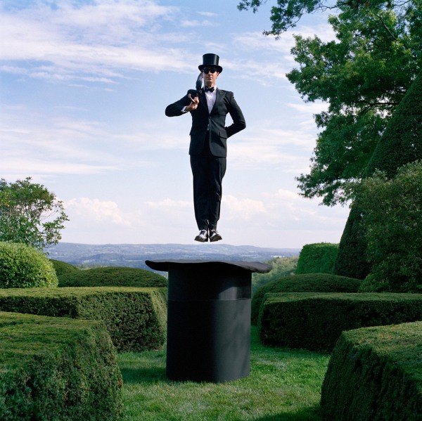 Rodney Smith, Reed Floating above Giant Top Hat with Umbrella, Amenia, New York, 2014
