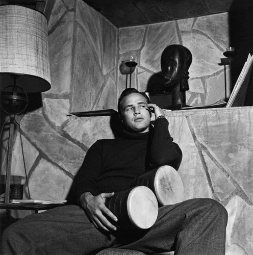 Sid Avery, Marlon Brando with bongo drums at his Beverly Hills home, 1955