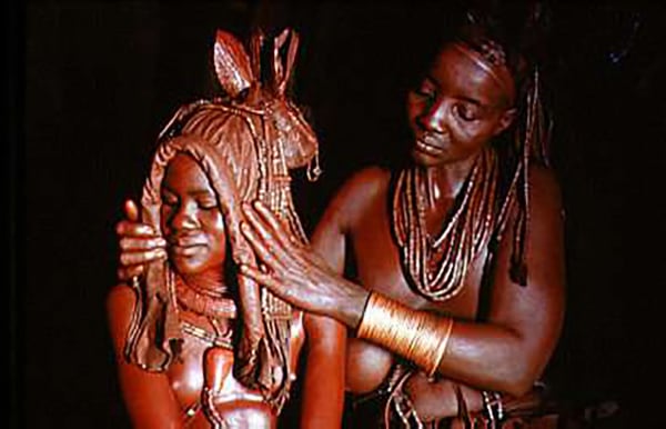 Carol Beckwith and Angela Fisher, Himba bride is prepared for marriage by her mother wearing an ekori headdress, Namibia