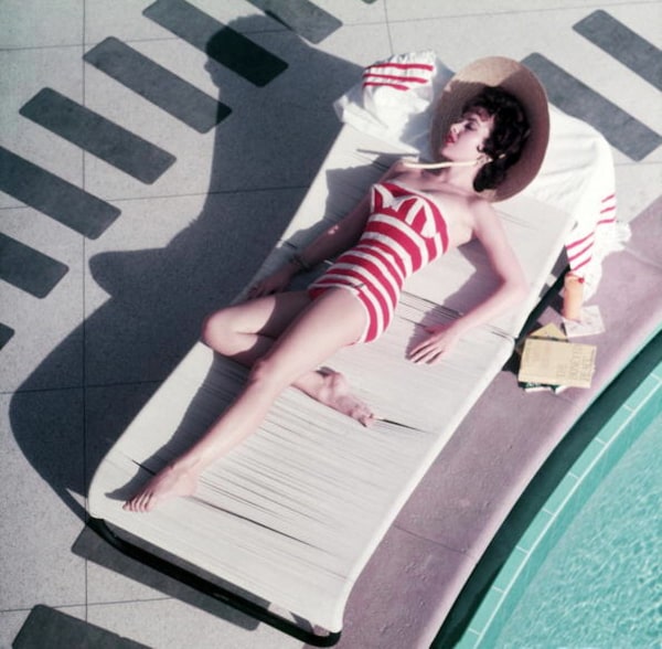 Slim Aarons, Mara Lane at The Sands, 1954: Austrian actress Mara Lane lounging by the pool in a red and white striped bathing costume, Las Vegas