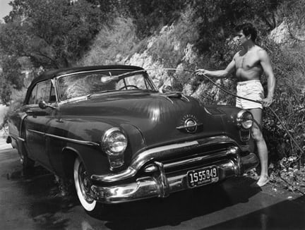 Sid Avery, Rock Hudson Washing his Oldsmobile Outside his Hollywood Hills Home, 1952