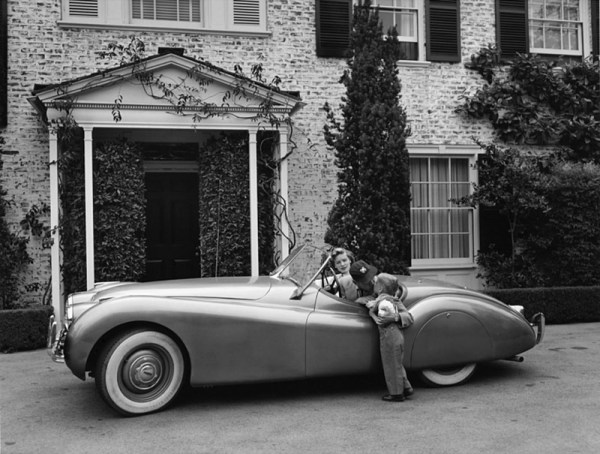 Sid Avery, Humphrey Bogart, Lauren Bacall and their son, Stephen, in their Jaguar XK 120 at home in Los Angeles, 1952