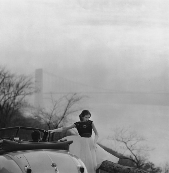 Tom Palumbo, Model in Front of the Golden Gate Bridge, Harper’s Bazaar, February (White chiffon joined with a bodice of black rayon and a waist winder of crushed red satin by Carlyle. Crystal and rhinestone earrings by Eisenberg), 1957