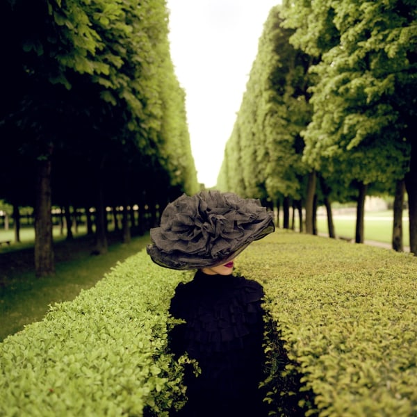 Rodney Smith, Woman with Hat Between Hedges, Parc de Sceaux, France, 2004