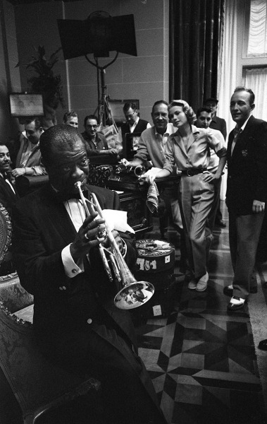 Bob Willoughby, Grace Kelly, Bing Crosby, and crew are treated to an impromptu concert by Louis Armstrong on the MGM set of &ldquo;High Society&rdquo;, 1956