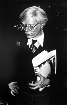 Anton Perich,  Andy Warhol holding newspaper, circa 1975