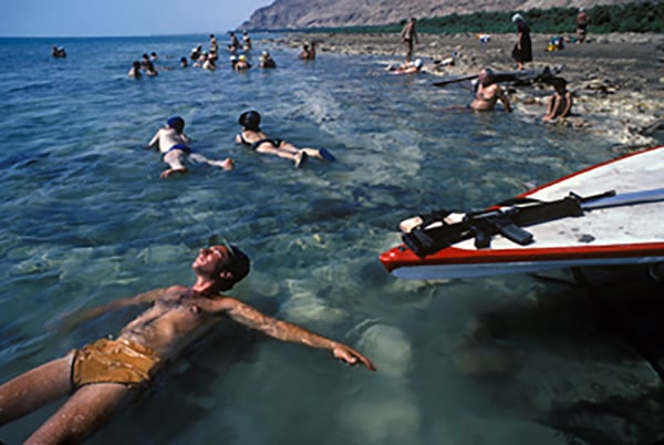 Harry Benson, Israeli Soldier relaxing in the Dead Sea, 1983
