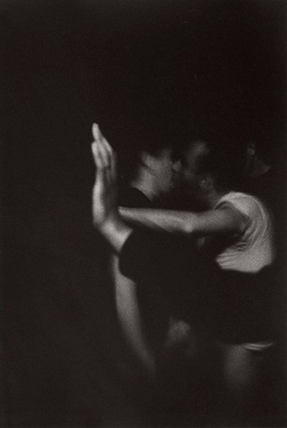 Men kissing against wall by Stephen Barker