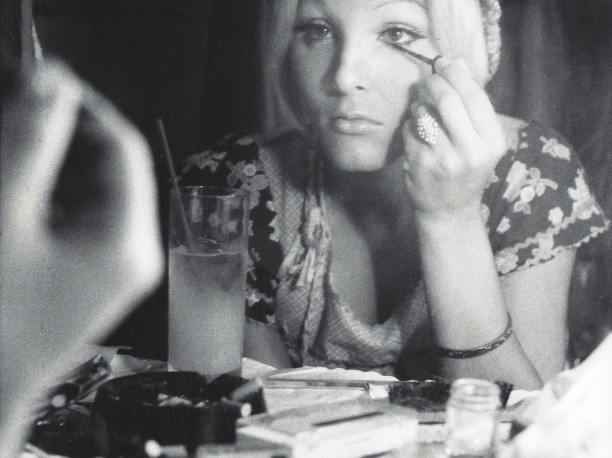Woman applying make up by Anthony Friedkin