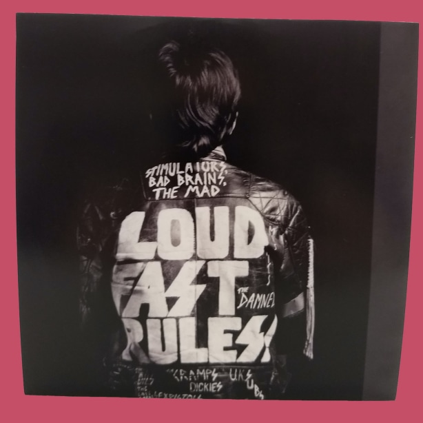 Album Cover Loud Fast Rules, Nick Marden photographed from behind in leather jacket covered in words.