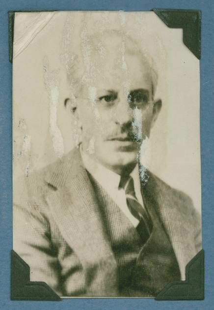 An old photograph of Leslie Nash in his middle years, in a suit and tie, with a serious expression. The photograph is faded. 