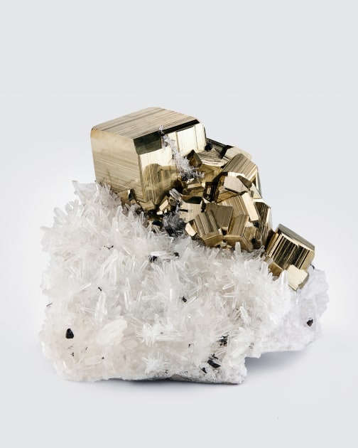 Fine mineral photograph of pyrite on white for wilensky exquisite minerals habits exhibition.