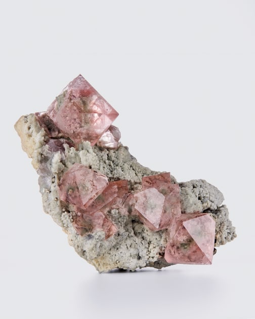 fine mineral photograph of pink fluorite on a white background for Wilensky Exquisite Minerals Habits exhibtion.