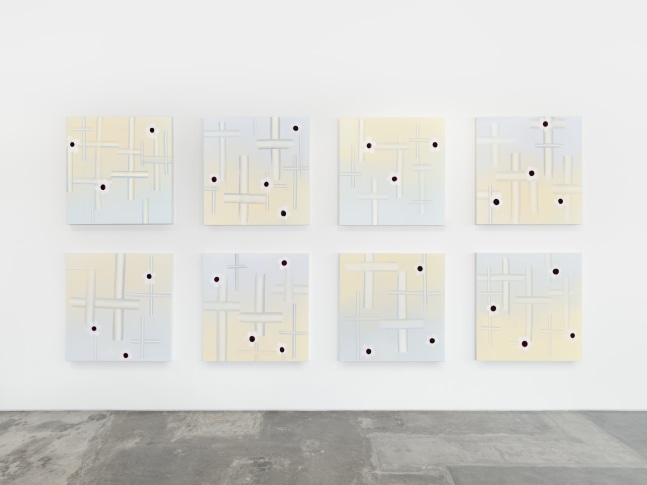 Installation view of Wanda Koop’s “Objects of Interest, Bullet Proof” at Night Gallery. 8 square canvas’ are arranged in two rows, each with depictions of crosses and flowers