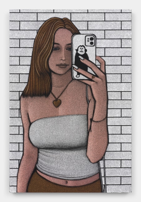 A woman with brown hair in a white tube top wearing a heart pendant necklace against a white brick wall taking a selfie with the viewer in the position of the mirror.