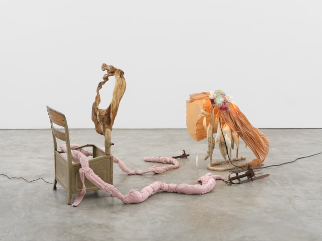 debt, 2022 found schoolchair, carved maple, polyester fleece, LED lights, paper collage, discarded garment rack, textile, resin, thread, plaster, epoxy clay, color pigment, beeswax, masking tape 37 x 60 x 38 in (94 x 152.4 x 96.5 cm)