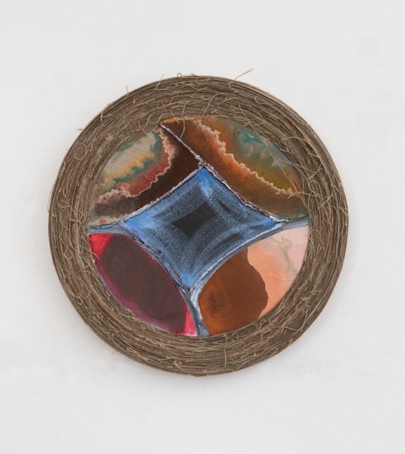 A tondo painting with a central blue diamond shape and pigment bleeding in from the edges that are wrapped in linen.