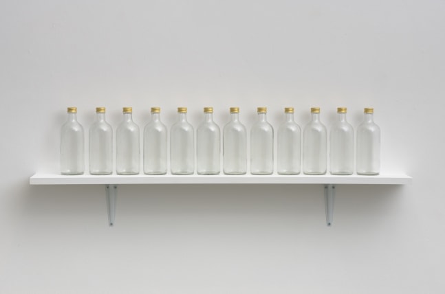 Untitled (Vapor Line), 2001-04
Twelve glass bottles, gold colored caps, water
8 x 44 x 3 inches,approximately