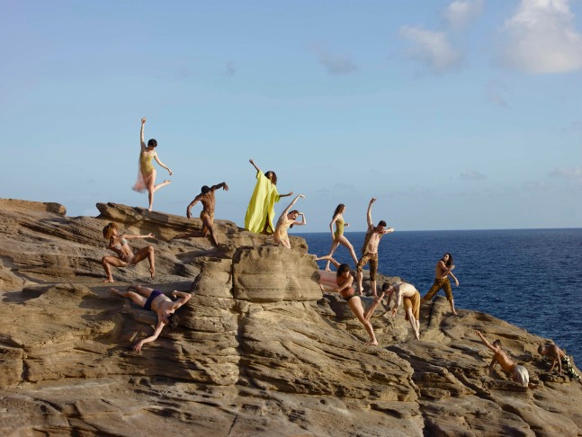 a group of dancers posing on the cliffs