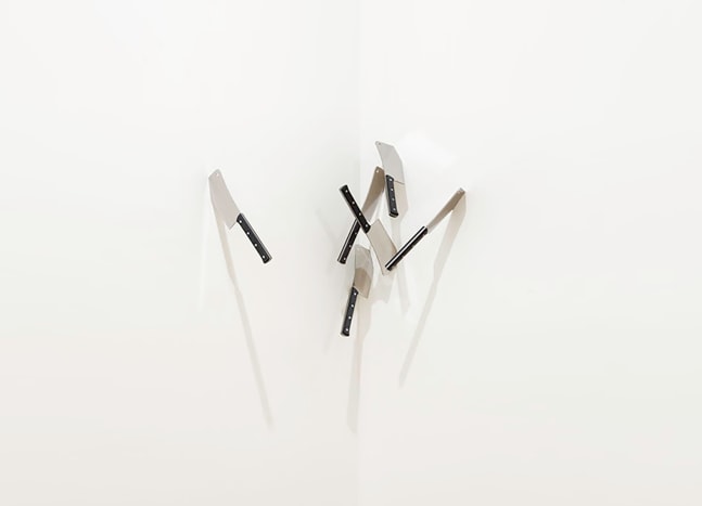 Installation view of 'Cleaved Corners (3)', 1969, six meat cleavers embedded in the corner of the gallery wall