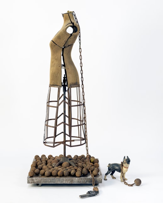 Karin Broker  Girl with balls, 2021 metal/cloth mannequin, Smith &amp; Wesson 357 Magnum, steel balls, chain, cast dog, steel base with wheels 63 x 27 x 27 inches (KB-262)     $40,000
