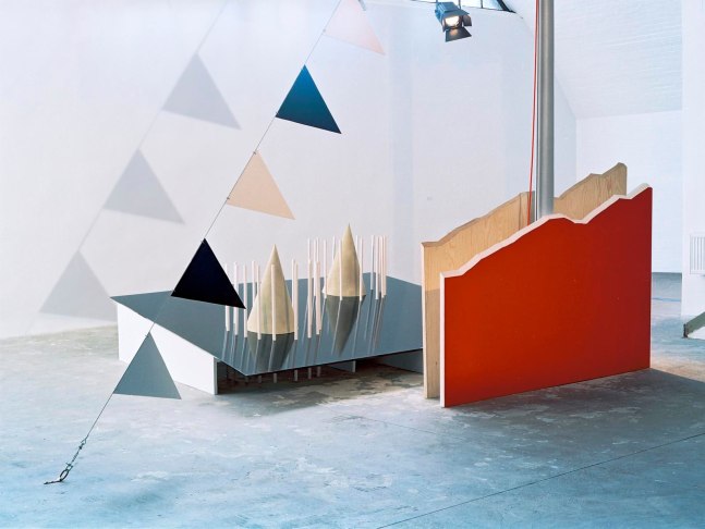 the iron table, 2002

painted wood, painted metal, sand, wire cable, synthetic cable, mast, 2 spotlights

90.55 x 212.6 x 208.66 in.

installation view of here and now,&amp;nbsp;b&amp;uuml;ro friedrich, berlin, 2002