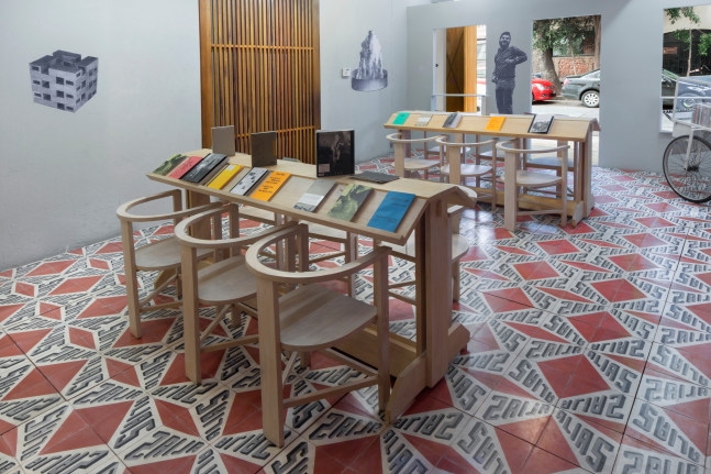 proyecto para biblioteca editorial alias, 2014

installation: 1 bookcase, 2 tables, 12 chairs, 1 balsa wood sign, 5 posters, 3 modules, 1&amp;nbsp;chicharronero&amp;nbsp;cart, cement tile floor over triplay&amp;nbsp;(376 ft2 approx.), 12 lamps, 10 complete&amp;nbsp;alias&amp;nbsp;collections (21 books each), 10 complete&amp;nbsp;ant&amp;iacute;tesis&amp;nbsp;collections&amp;nbsp;(5 books each)

variable dimensions